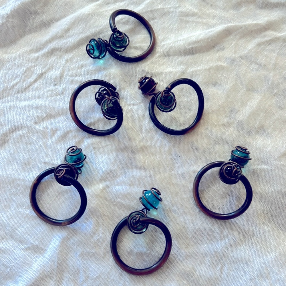 Set of 6 brass and glass twisted napkins holders.